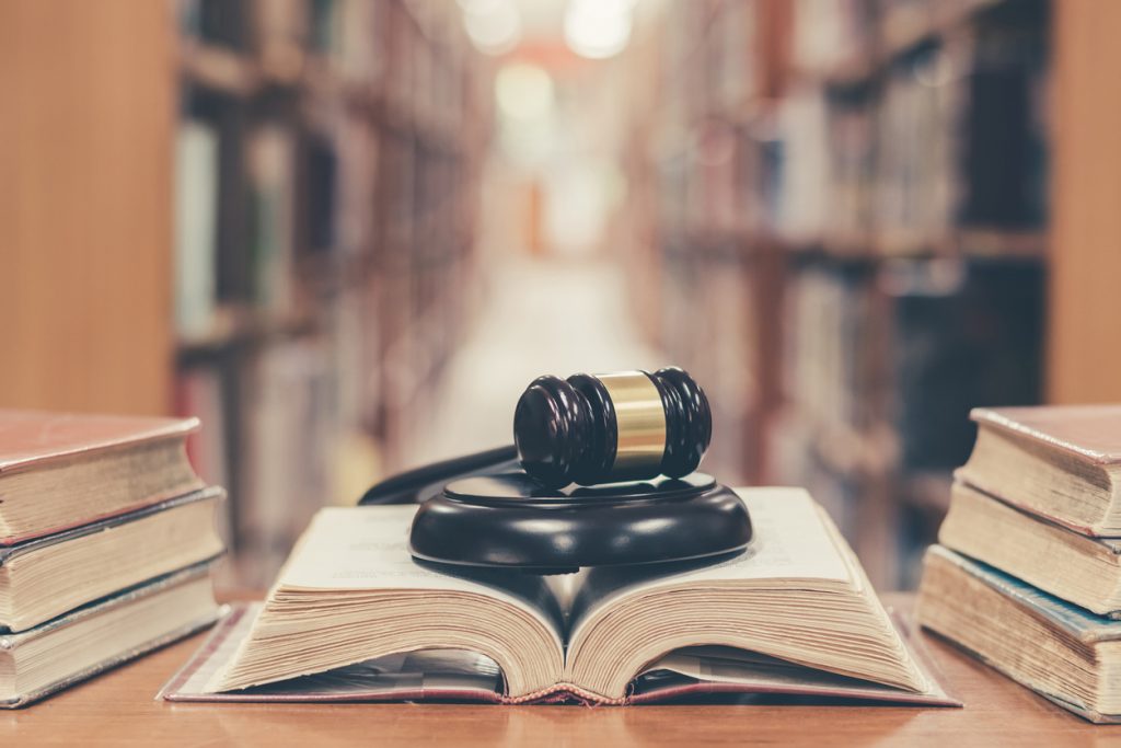 Judge gavel on top of a book in a library